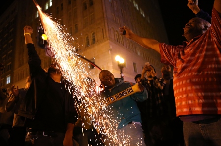 OAKLAND, CA - JUNE 16:  Golden State Warriors fans celebrate their team's 2015 NBA Finals win outside of Oakland City Hall on June 16, 2015 in Oakland, California. This is the first championship win for the Warriors since 1975.  (Photo by Justin Sullivan/Getty Images)